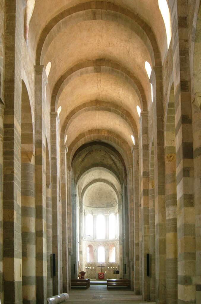 Interior of Payerne Priory, featuring Romanesque architecture.