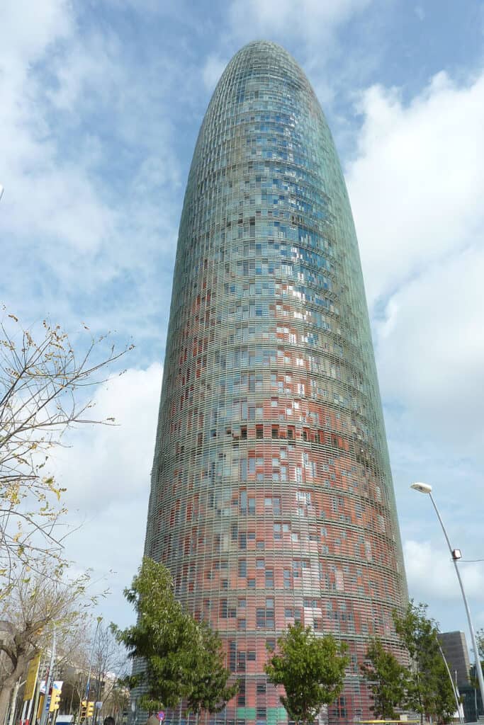 Daytime view of Torre Glòries, a modern skyscraper in Barcelona.