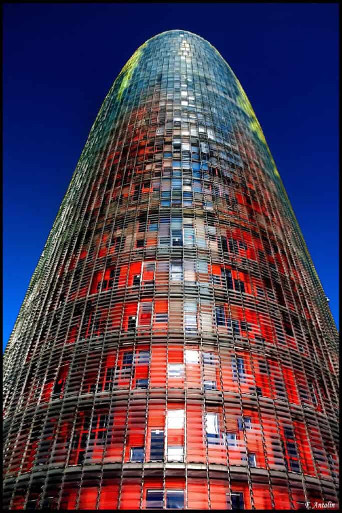 Torre Glòries in Barcelona, a modern skyscraper with a bullet-shaped design.