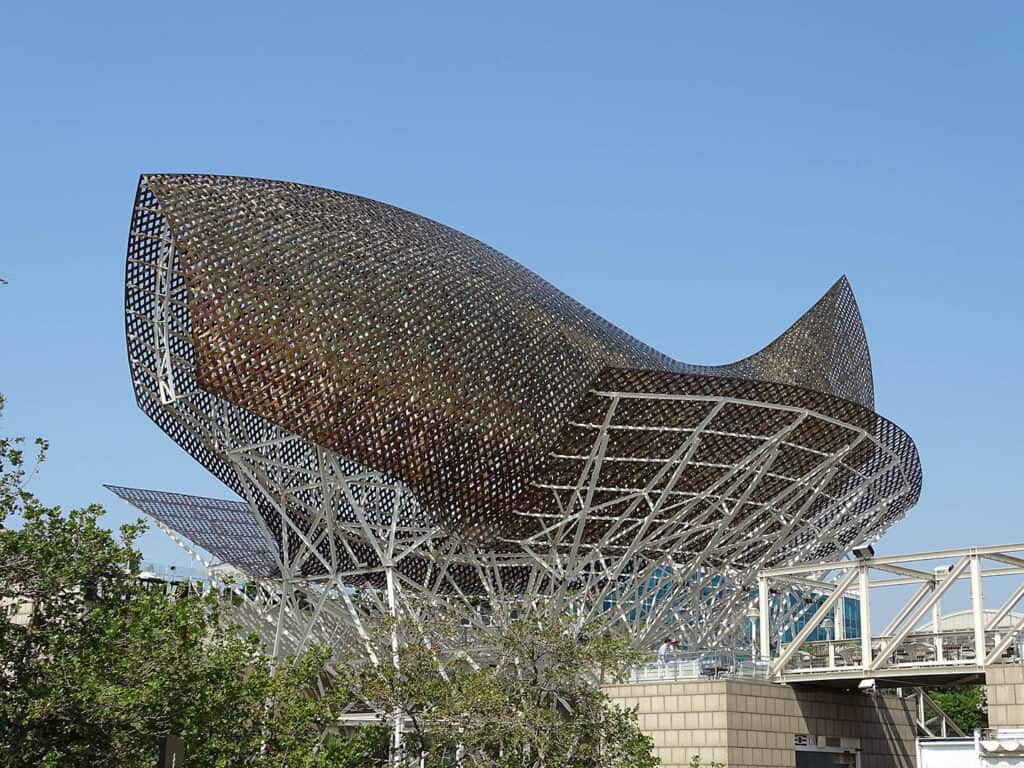 Golden metal fish sculpture by Frank Gehry in Barcelona.