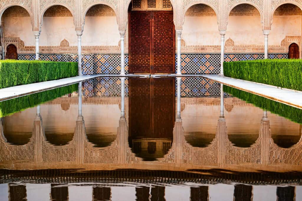 Reflection of the Alhambra Palace in a tranquil pool.