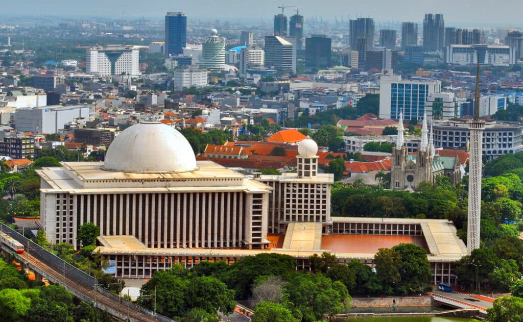 Istiqlal Mosque against the Jakarta skyline.