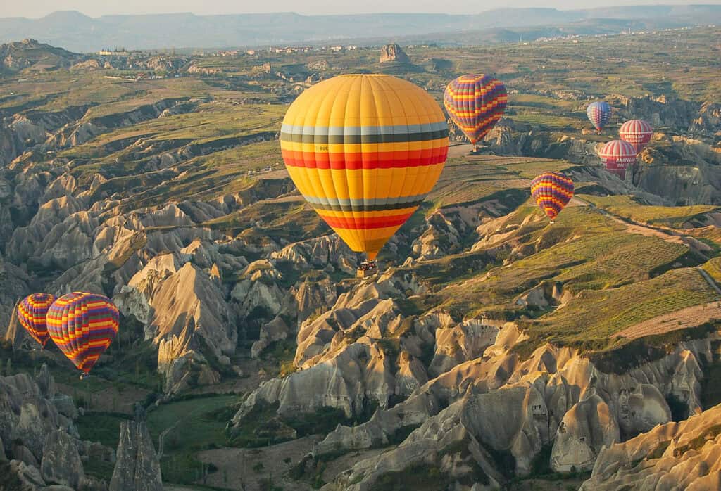 Hot air balloons over Cappadocia’s rock formations.