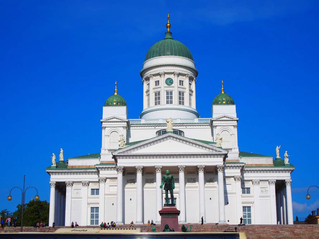 Helsinki Cathedral with white facade and green domes.