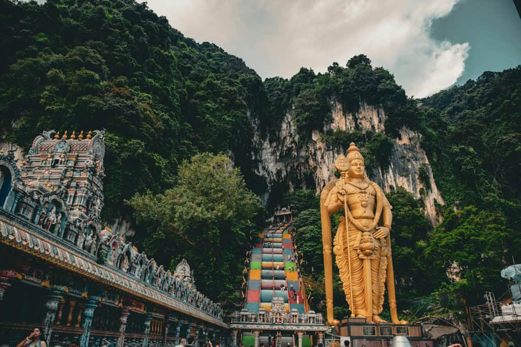 Batu Caves Temple with towering golden statue in Malaysia.