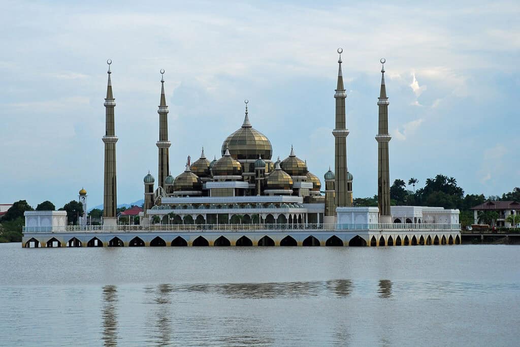 Crystal Mosque illuminated at night.