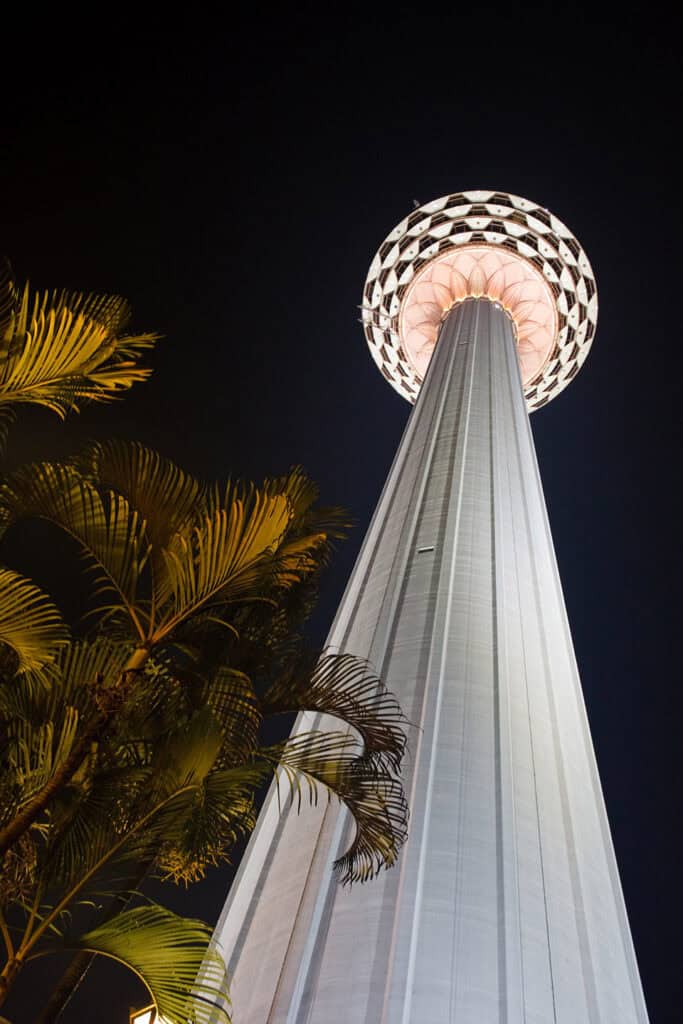 KL Tower illuminated at night in Kuala Lumpur.